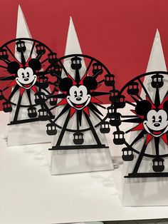 three mickey mouse coasters sitting on top of a white table next to each other