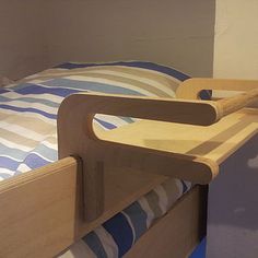 a bed with a wooden headboard and foot board on it's bottom bunk