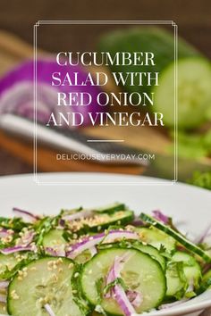 cucumber salad with red onion and vinegar in a white bowl on a wooden table