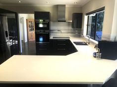 a modern kitchen with black and white appliances