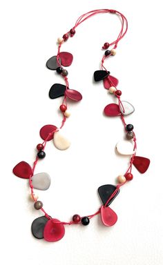 Multi-Color Tagua Long Necklace  Ecuadorean Tagua Jewelry - Eco Friendly Color: red, black, gray, white Multi-Color Part Number: TAG541 Item Weight: 2oz Product Length: 40 inches long adjustable to shorter length About Tagua This Product is handcrafted from a palm tree nut native to the lush tropical rain forests of Ecuador. Also referred to as the Ecuadorean Palm, the Tagua tree produces several bushels of seed pods a year with up to 100 Tagua nuts per pod. These nuts are then harvested, dried, Bracelet En Cuir Diy, Tagua Necklace, Ivory Necklace, Diy Leather Bracelet, Tagua Jewelry, Tagua Nuts, Seed Pods, Leather Diy, Everyday Items