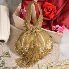 This wedding bridal potli is a beautiful and elegant handcrafted golden potli with fringes and drop pearls on the end. Formal Gold Potli Pouch Bag, Gold Openable Potli Bag For Wedding, Formal Gold Pouch Potli Bag, Gold Handheld Shoulder Bag Gift, Elegant Gold Gift Pouch, Elegant Gold Pouch Gift Bag, Elegant Gold Gift Bag Pouch, Gold Festive Handheld Evening Bag, Gold Pouch Bag For Reception