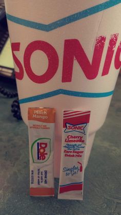 some toothpaste sitting on top of a white cup with the word sonic written on it