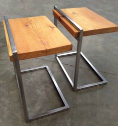 two wooden tables sitting side by side on concrete floored area with metal frame legs