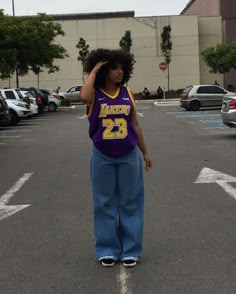 a woman standing in the middle of a parking lot