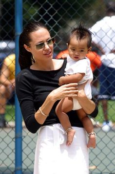 a woman holding a baby in her arms