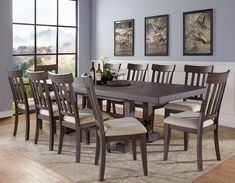 a dining room table with six chairs around it