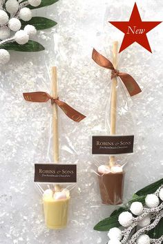 two small candles wrapped in cellophane and tied with ribbon on top of snow