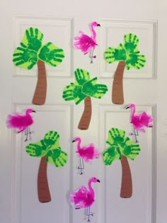 handprint palm trees and flamingos are on the door to make this tropical art project