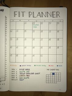 a planner is open on top of a wooden table