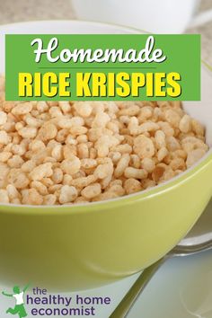 a green bowl filled with rice krispies on top of a white plate next to a cup