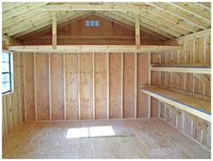 an empty room with wooden walls and shelves