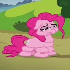 the pinkie is sitting on the ground looking at something