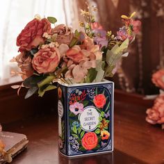 a vase filled with flowers on top of a wooden table