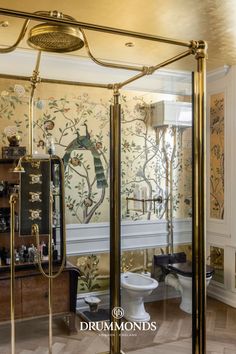 a fancy bathroom with gold fixtures and wallpaper