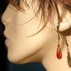 These pretty Orange Chalcedony Teardrop Dangle Earrings are suspended from oxidized brass ear wires - simple and elegant with just the right amount of sparkle! They weigh about 2 grams and hang - from antiqued brass ear wires - just over 1 1/2 inches (40mm) from your earlobe, dangling freely - very nice! The teardrop shaped chalcedony beads are approximately 7mm across (about 1/4 inch), and 15mm long (about 5/8 inch), and they are each accented by an oxidized brass bead cap and a small Swarovski Red Topaz, Pretty Orange, Topaz Crystal, Teardrop Dangle Earrings, Bead Caps, Ear Wires, Topaz, 4 Inch, Dangle Earrings