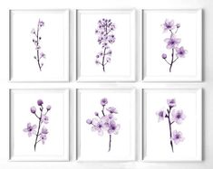 four purple flowers are displayed on the wall in front of a white background, and one is