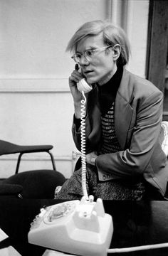 a woman sitting at a table talking on the phone