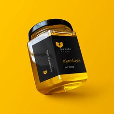 a jar of honey on a yellow background with the label in black and white, which reads alkadiya