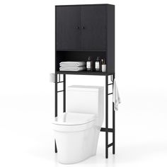 a white toilet sitting next to a black cabinet on top of a shelf above it