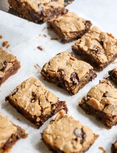 chocolate chip cookie bars are lined up on a baking sheet and ready to be eaten