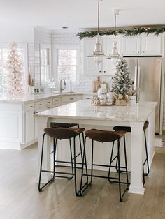 two stools sit at the center of a kitchen island