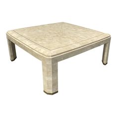 a white square table sitting on top of a wooden floor