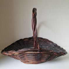 a wicker basket sitting on top of a white table