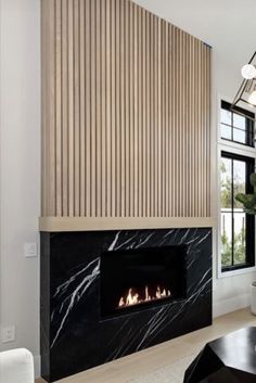 a living room filled with furniture and a fire place in the middle of it's wall