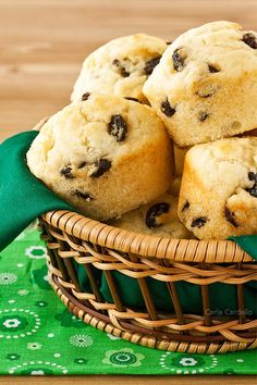 chocolate chip muffins in a wicker basket on a green napkin with a green cloth