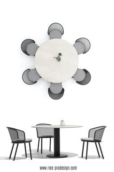 a white table with four chairs and a clock on the wall above it that says, this is division com