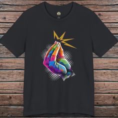 a black t - shirt with an image of a hand holding a star