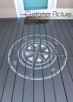 the floor is painted with white paint and has a compass on it, as well as a door