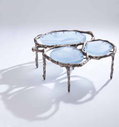 three blue glass trays sitting on top of each other in front of a white background