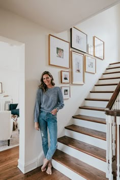 a woman standing in front of some stairs