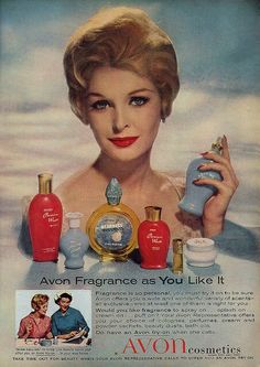 an ad for avon perfumes with a woman holding up her bottle