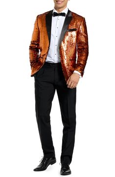 Drenched in golden sequins and finished with satin lapels, the jacket of this entrance-making tuxedo pairs with pleated black trousers and a coordinating bow tie to finish the standout look. Jacket has peaked lapels; four-button cuffs; chest pocket; welt pockets; interior pockets; side vents Trousers have zip fly with button-tab closure; slant pockets; back pockets Jacket is lined Unhemmed 100% polyester Machine wash, line dry Imported Party Suits With Sequins, Sequin Party Suits, Sequin Party Suits For Party Season, Glamorous Party Suit With Sequins, Glamorous Fitted Suits For Party, Long Sleeve Suits For Night Out And Party Season, Long Sleeve Suits For Night Out Party Season, Long Sleeve Suits For Party Season, Gold Fitted Tuxedo For Formal Occasions