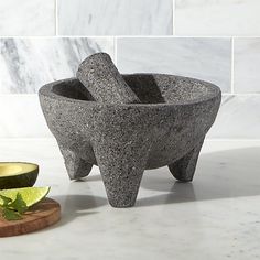 a bowl that is sitting on a counter next to a slice of avocado