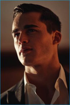 a close up of a person in a suit and tie looking off to the side