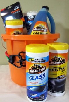 an orange bucket filled with cleaning products on top of a table