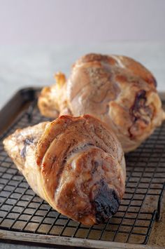 two pastries sitting on top of a cooling rack