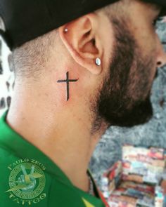 a man with a cross behind his ear