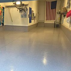 the inside of a garage with an american flag hanging on the wall