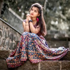 a beautiful young woman sitting on the steps