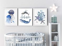 three watercolor paintings on the wall above a crib in a baby's room