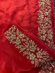 a red dress with gold embroidery on it