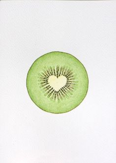 a kiwi cut in half sitting on top of a piece of paper