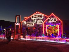 a house covered in christmas lights at night