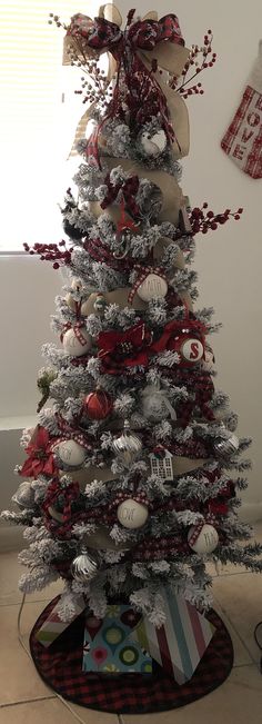 a decorated christmas tree with red and white ornaments