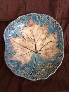 a plate with a leaf design on it